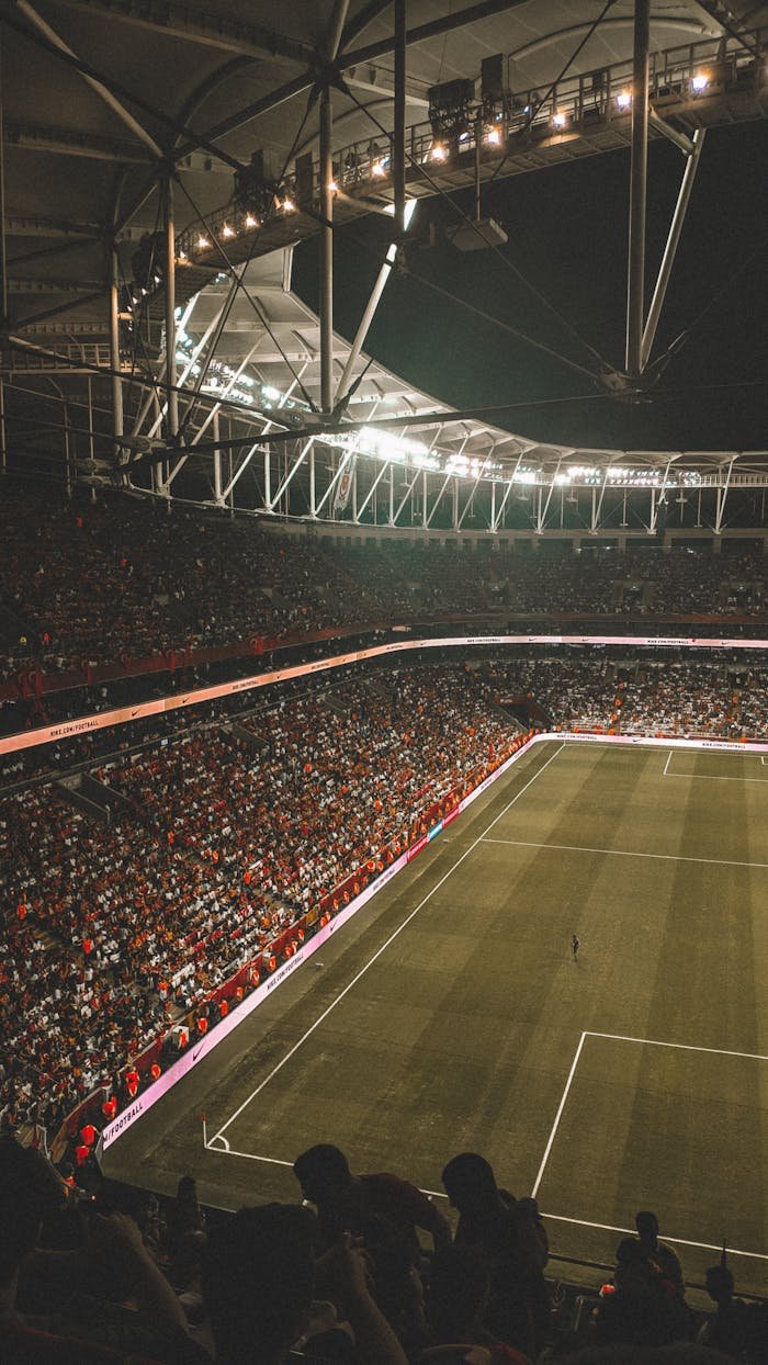 why-choose-us A vibrant night soccer match with a full audience in an illuminated stadium.